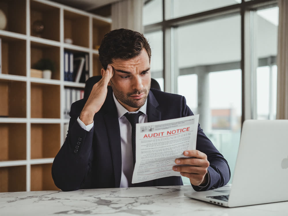 Business owner reading an IRS audit notice with concern