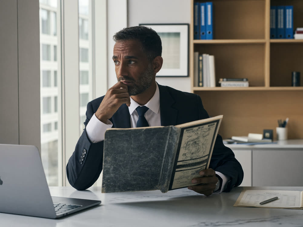 Business owner reviewing outdated business entity formation paperwork