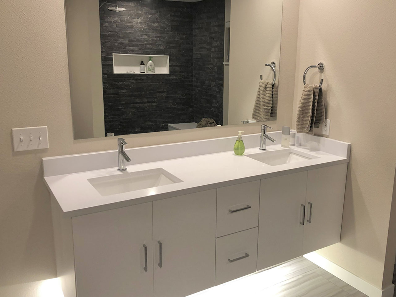 Modern double vanity bathroom with under-cabinet lighting