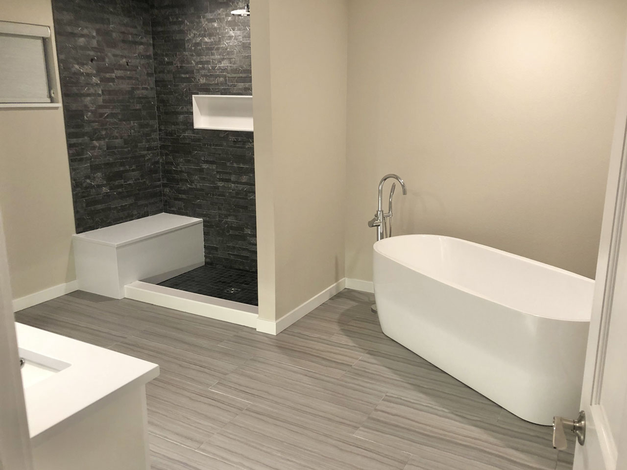 Spa bathroom with freestanding soaking tub and stone shower
