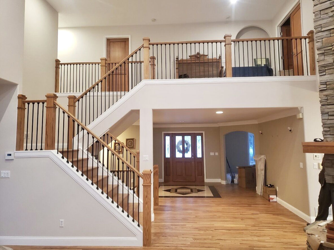 Two-story entry staircase with wrought iron balusters