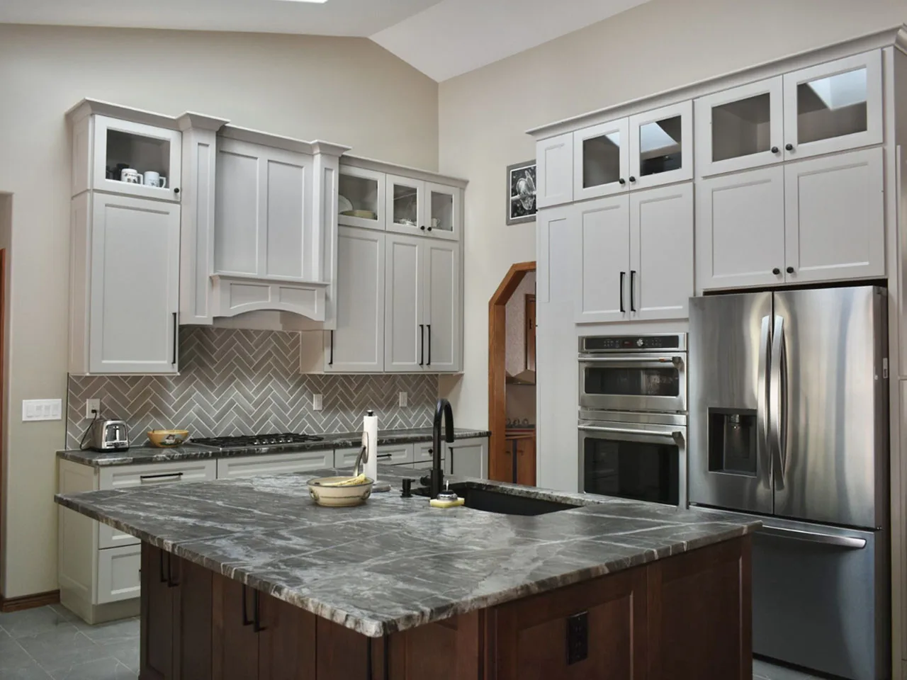 Kitchen remodel with curved granite bar seating