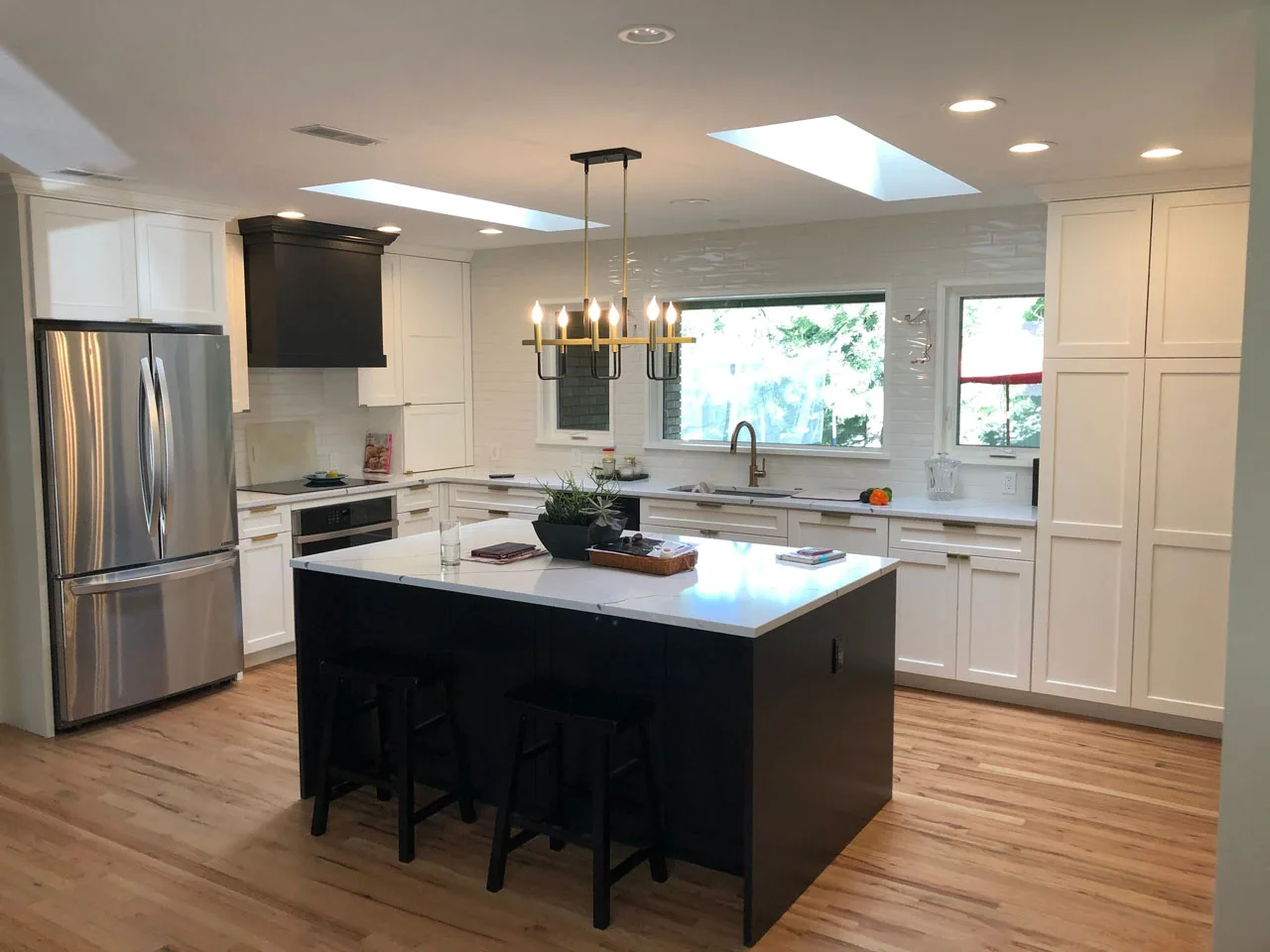 Bright white kitchen remodel with dual skylights
