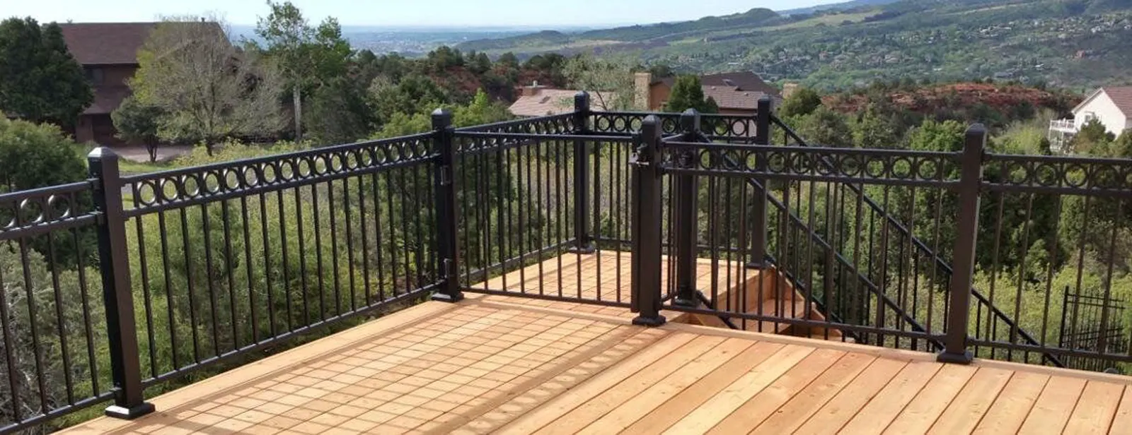 Elevated deck with wrought iron railing and mountain view