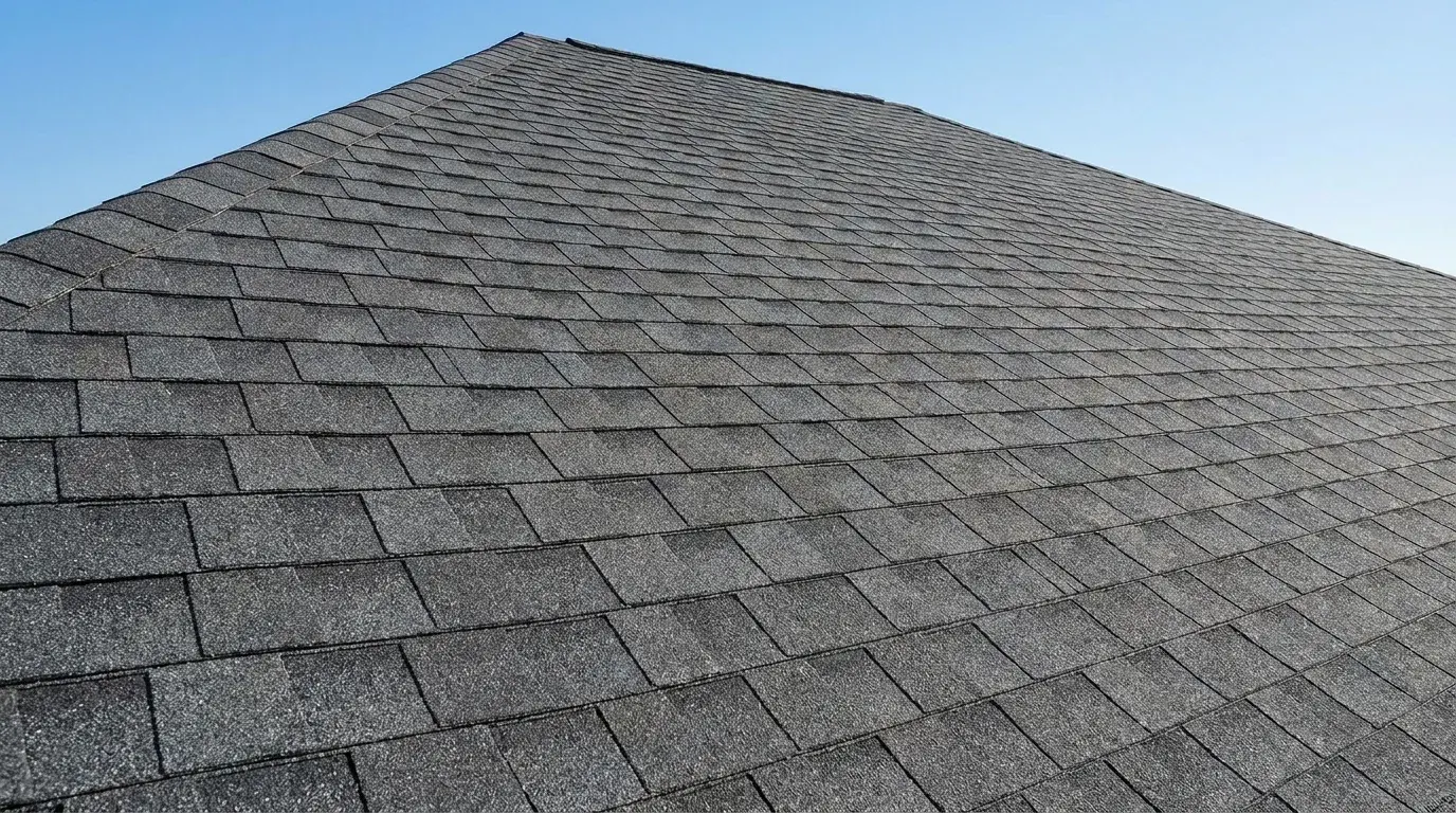 Close-up of dark grey architectural shingles with clean, uniform lines
