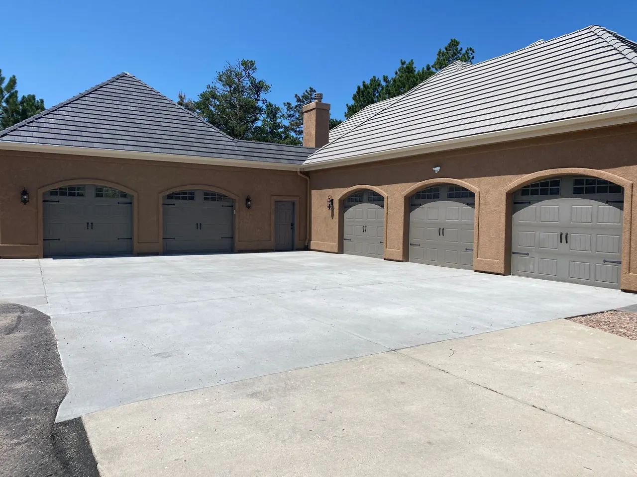 Five-bay garage addition with matching carriage doors