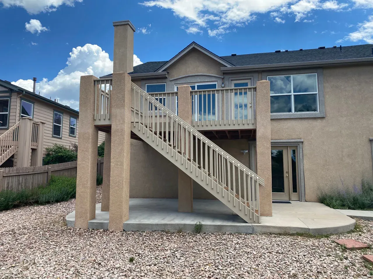 Full home exterior with new deck and staircase