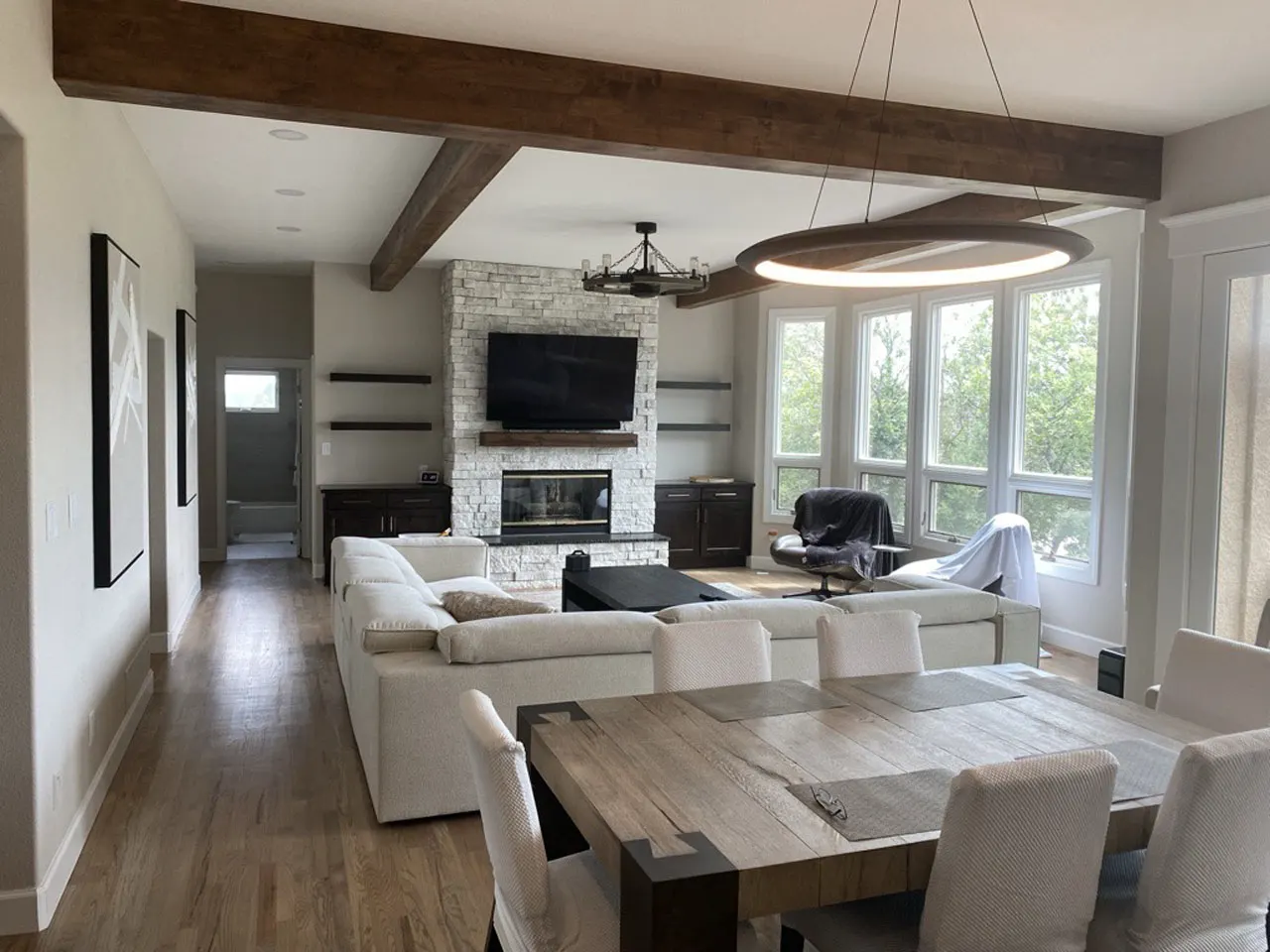 Great room with wood beam ceiling and stone fireplace