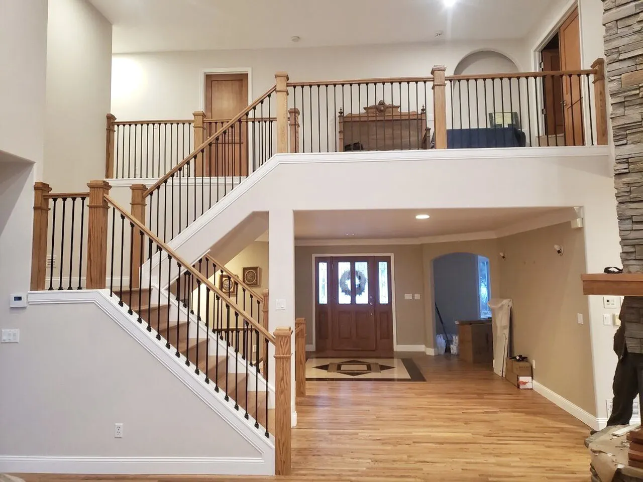 Two-story entry staircase with wrought iron balusters