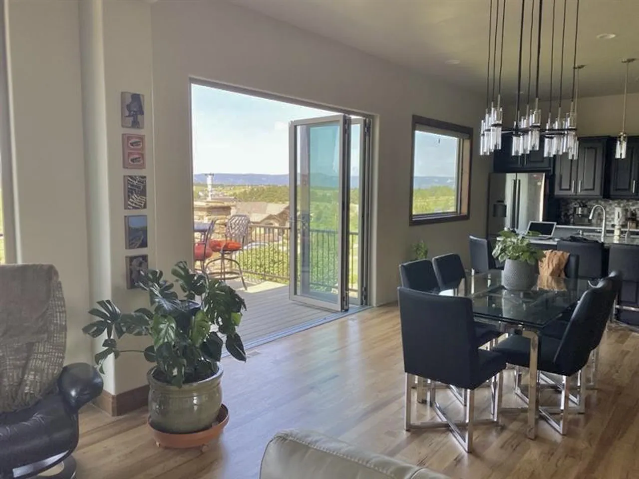 Dining area opening to deck through folding glass doors