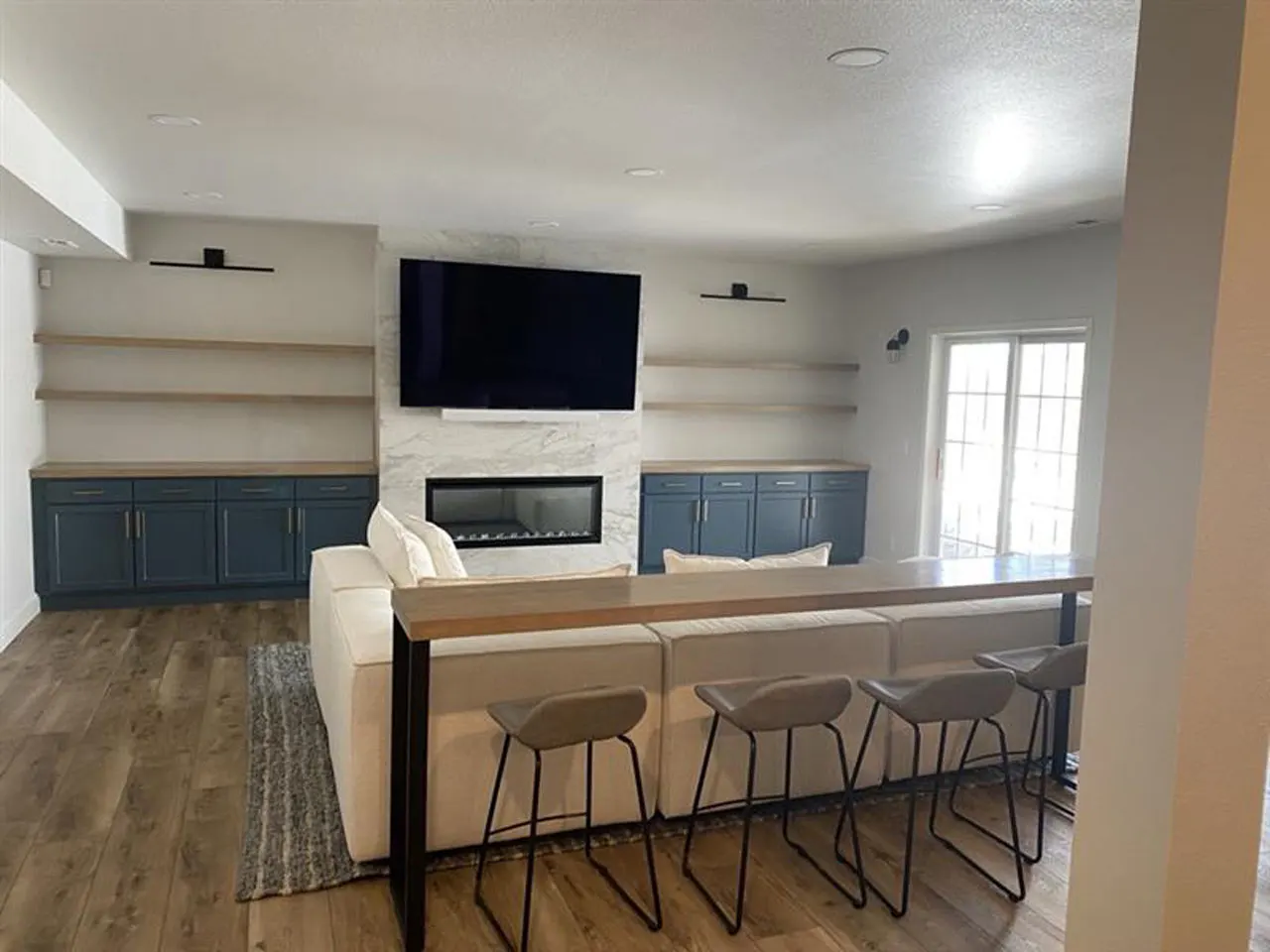 Living room with custom built-in shelving and fireplace