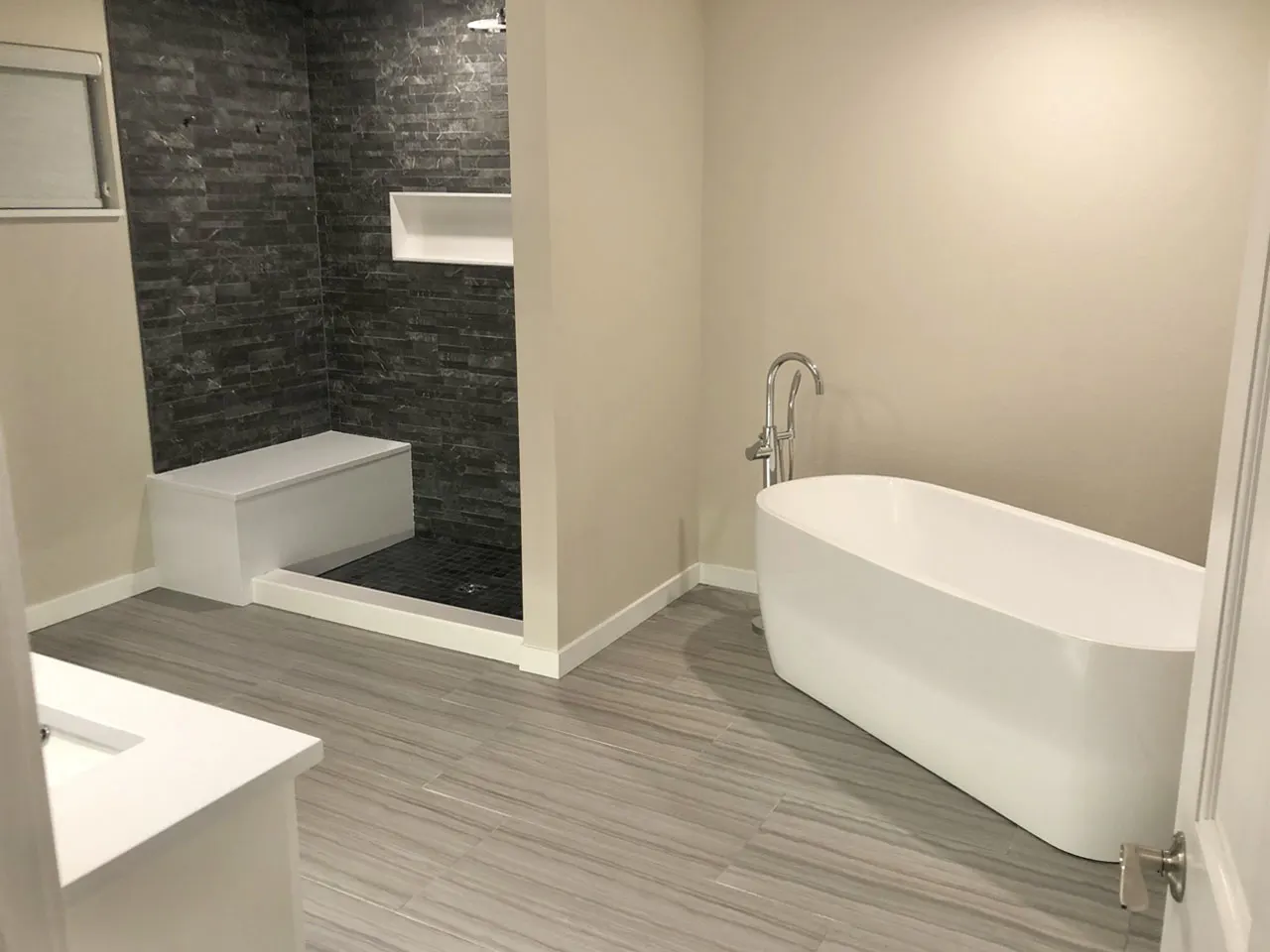 Spa bathroom with freestanding soaking tub and stone shower