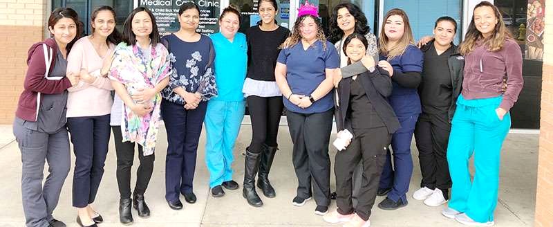 Members of the Millennium Medical Care team outside one of the group's clinics