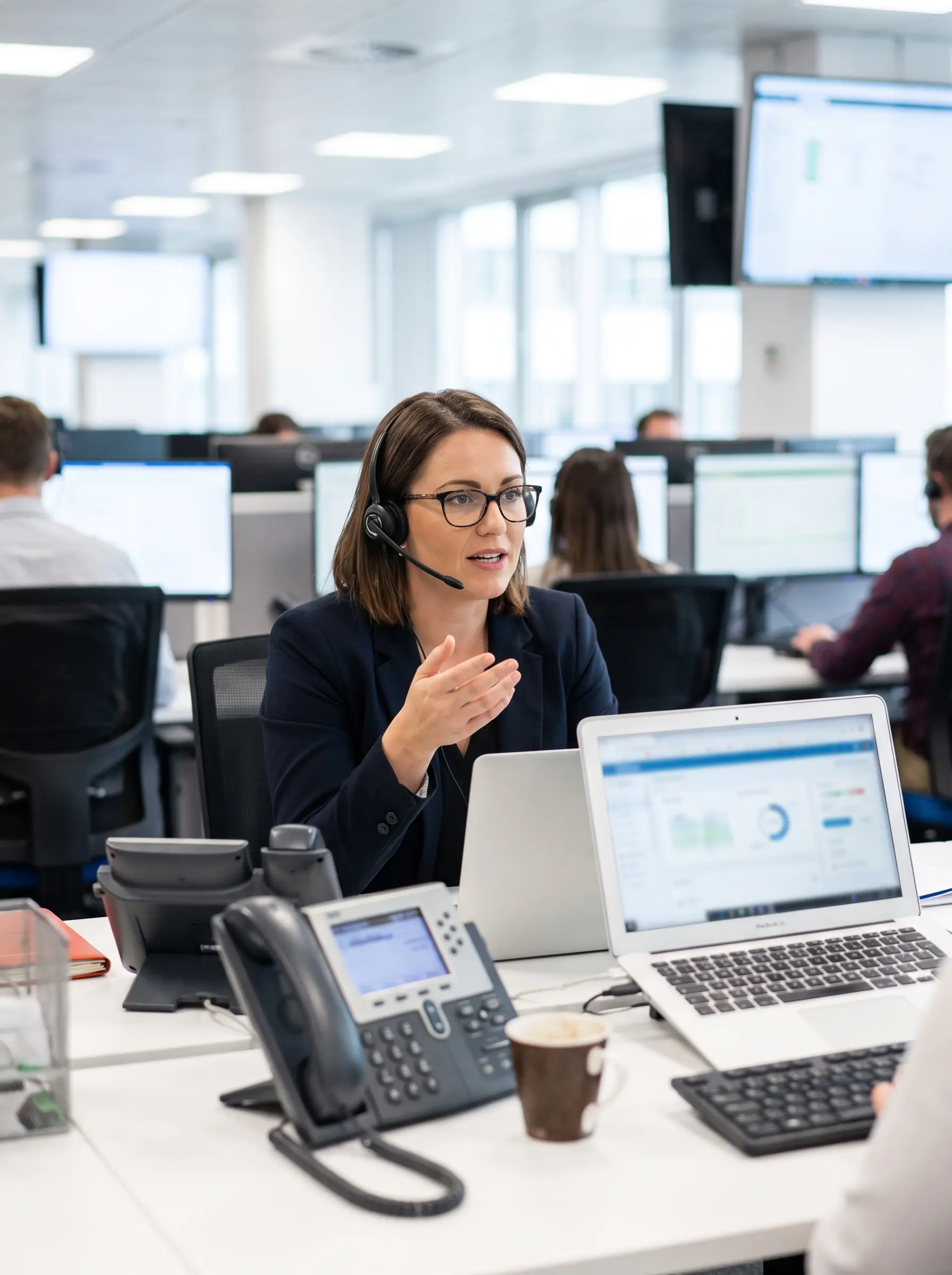 Customer service representative wearing a headset at a desk