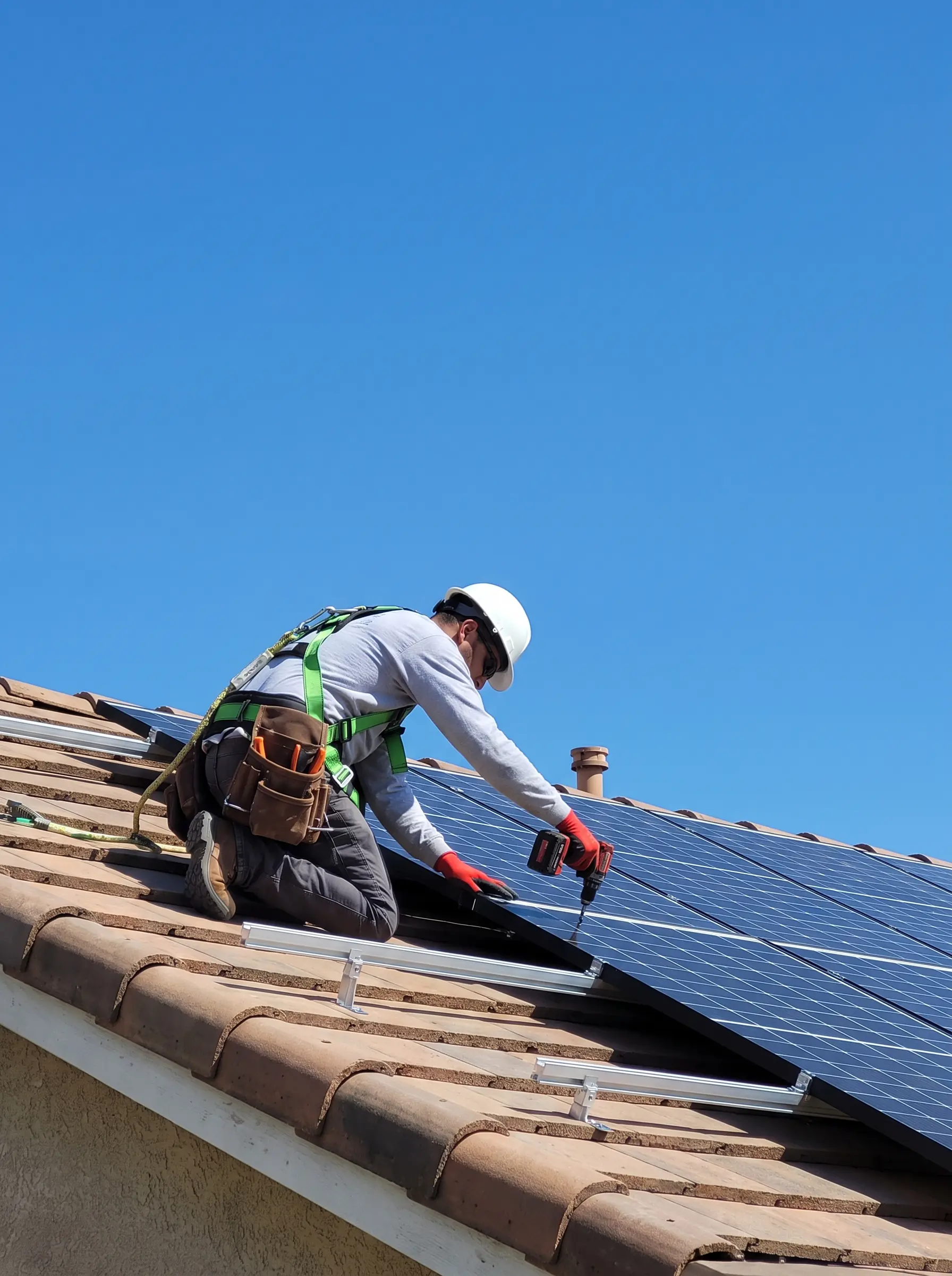 Solar installer mounting panels on a residential roof