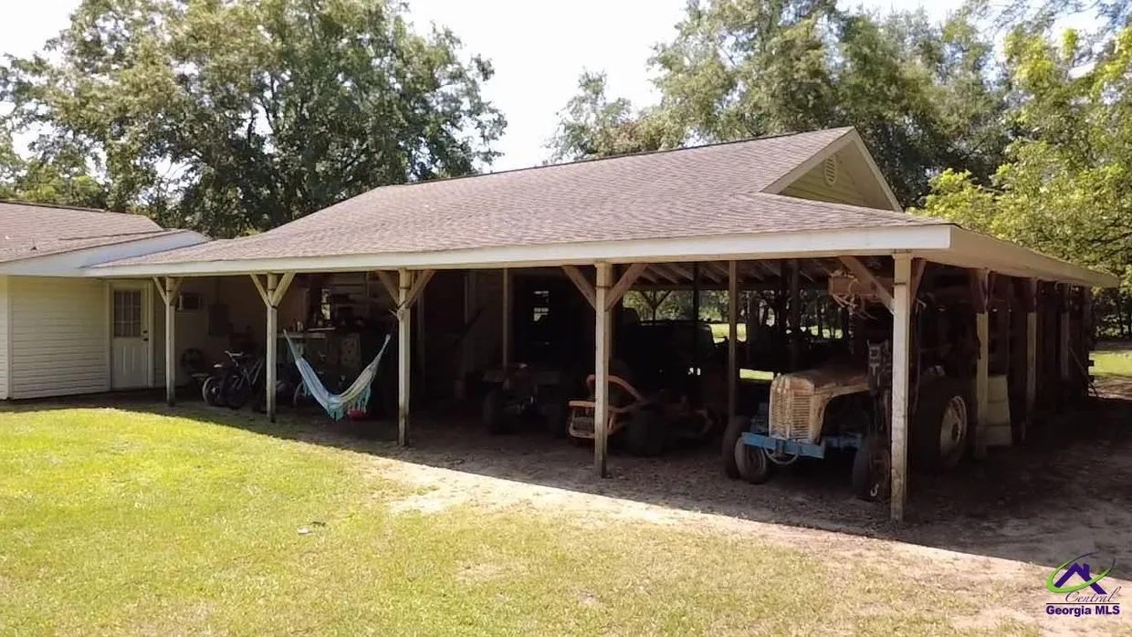 Large open pole barn beside the home