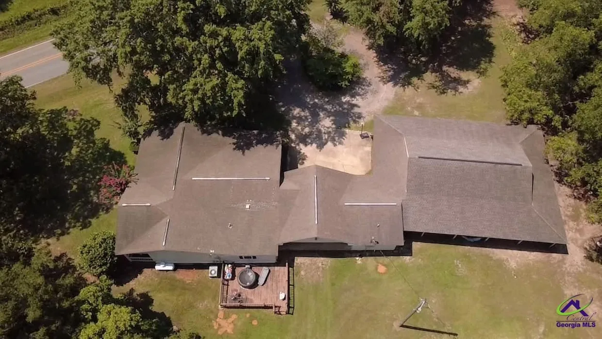 Aerial view of the home, carport, and pole barn