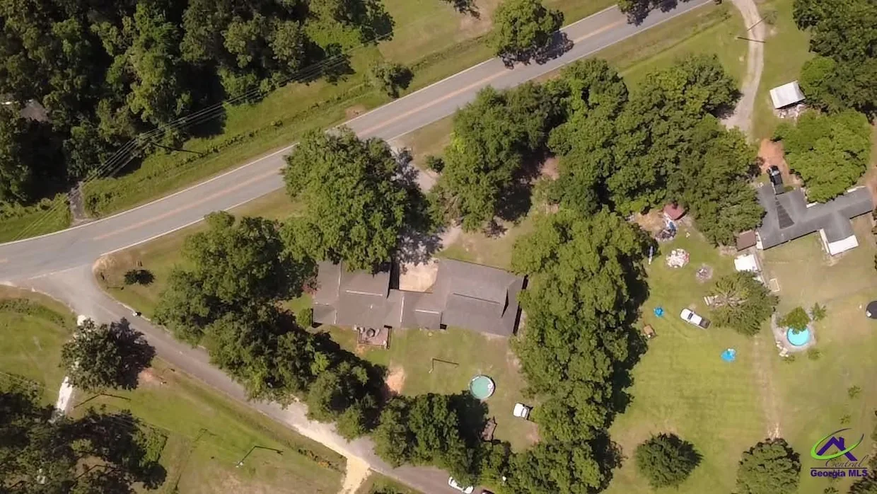 Aerial view of the property under mature trees