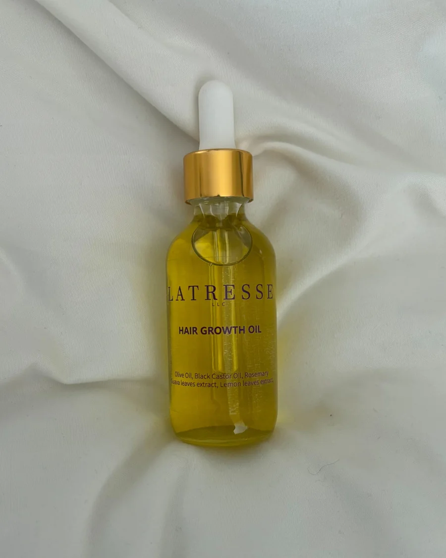 La Tresse Hair Growth Oil in a glass dropper bottle with a gold cap