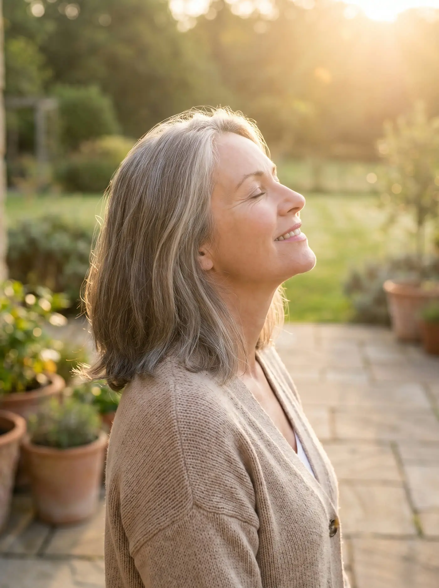 A woman smiling as she enjoys a quiet morning outdoors