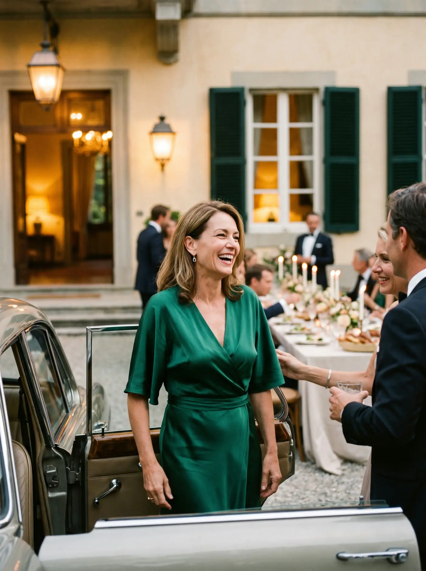 A woman in an elegant dress arriving at a dinner