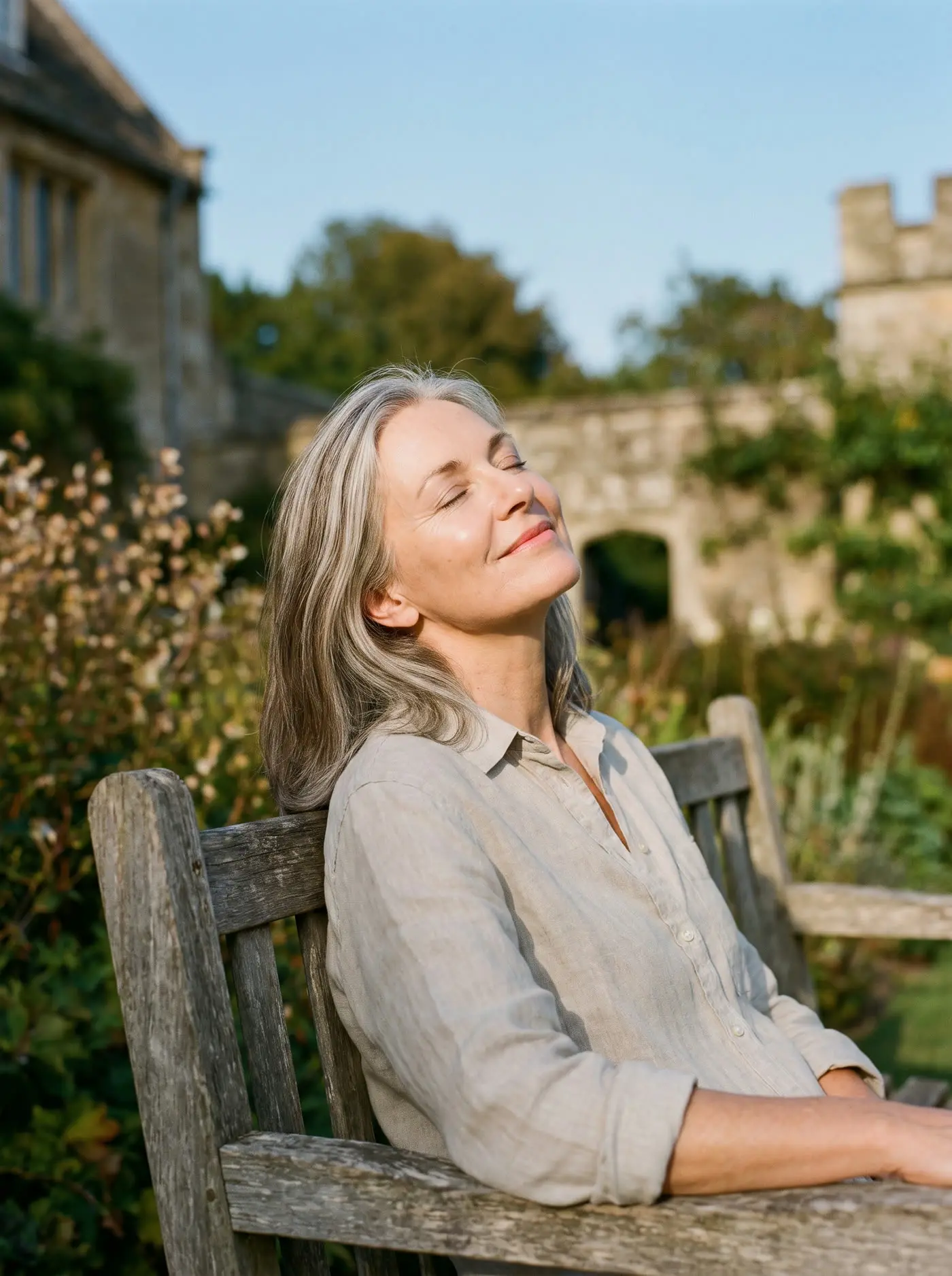 A woman closing her eyes and enjoying the sun on her face