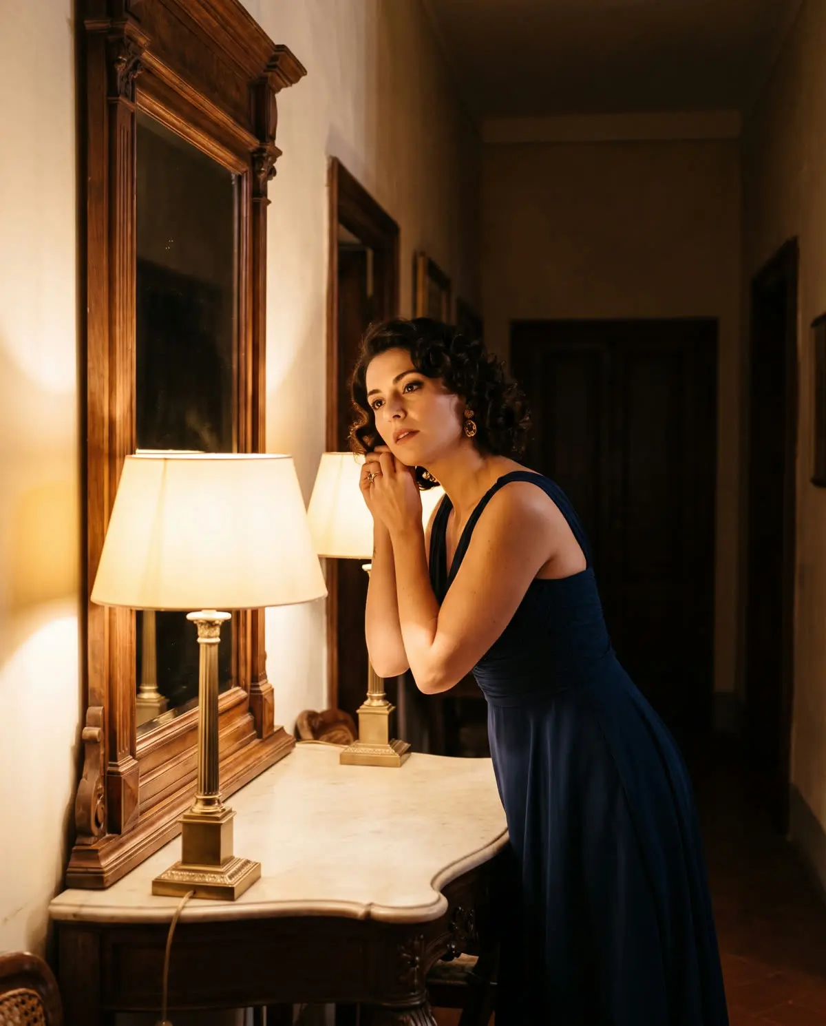 A woman in an elegant dress at a hallway mirror before an evening out