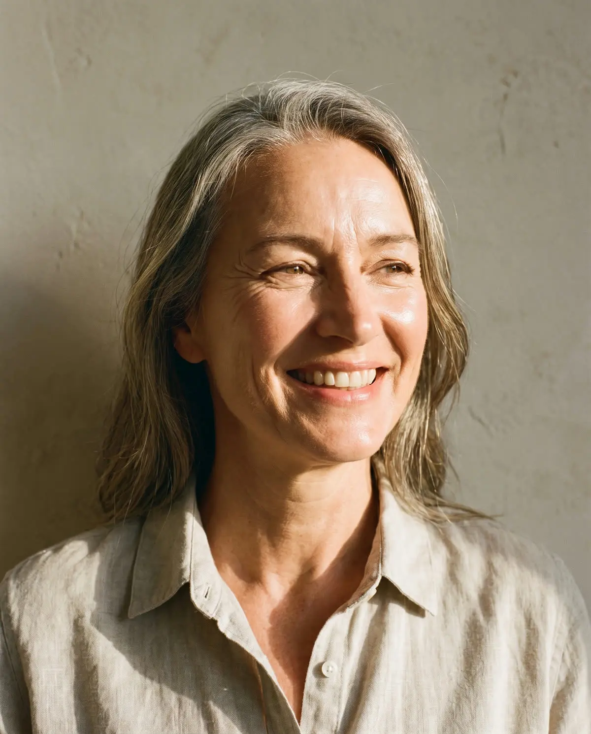 A smiling woman with healthy, glowing skin