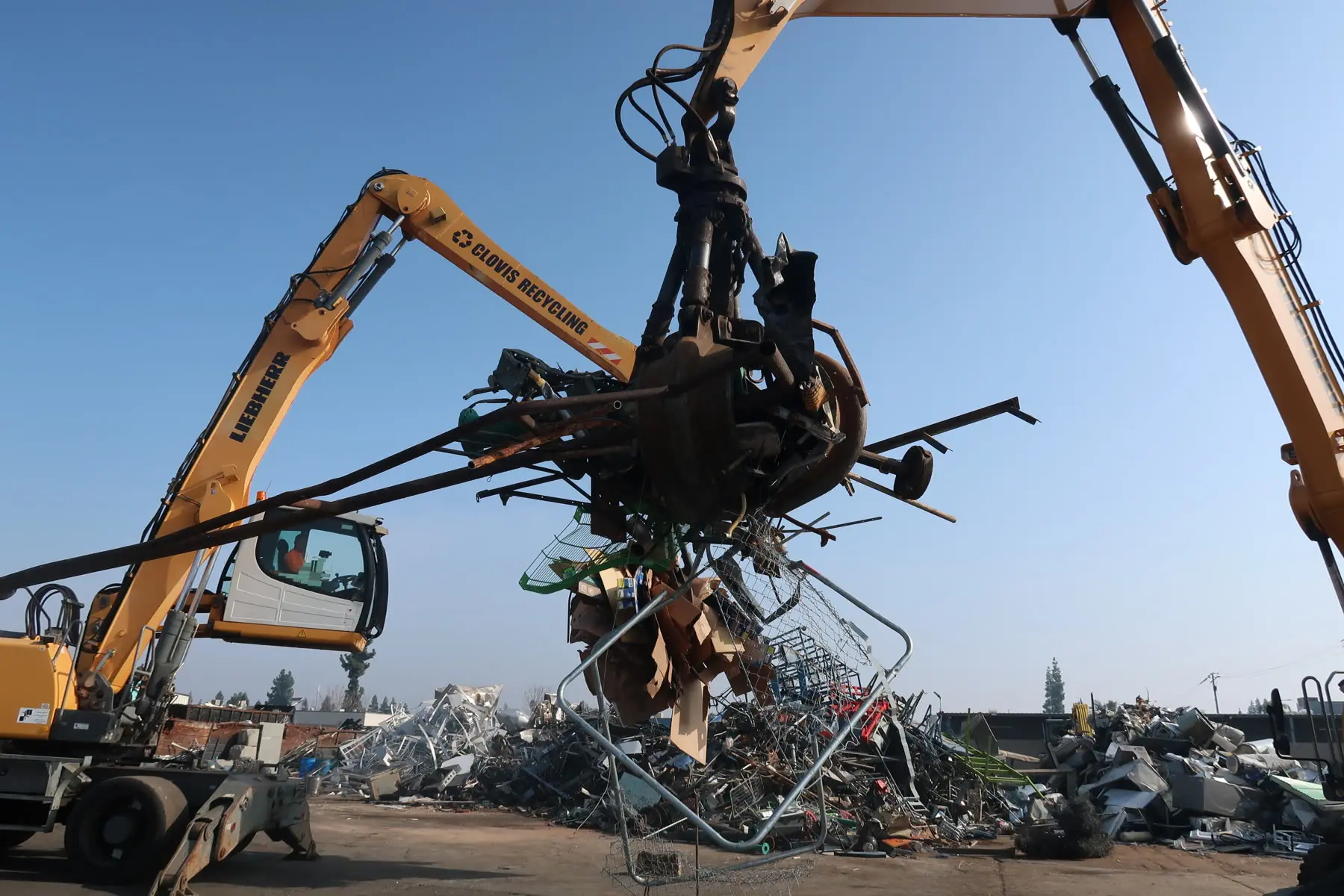 A Clovis Recycling material handler lifting a load of scrap metal at the Hoblitt Avenue yard