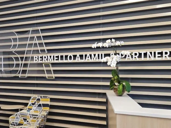 Finished office reception wall with dimensional lettering and wood slat finish